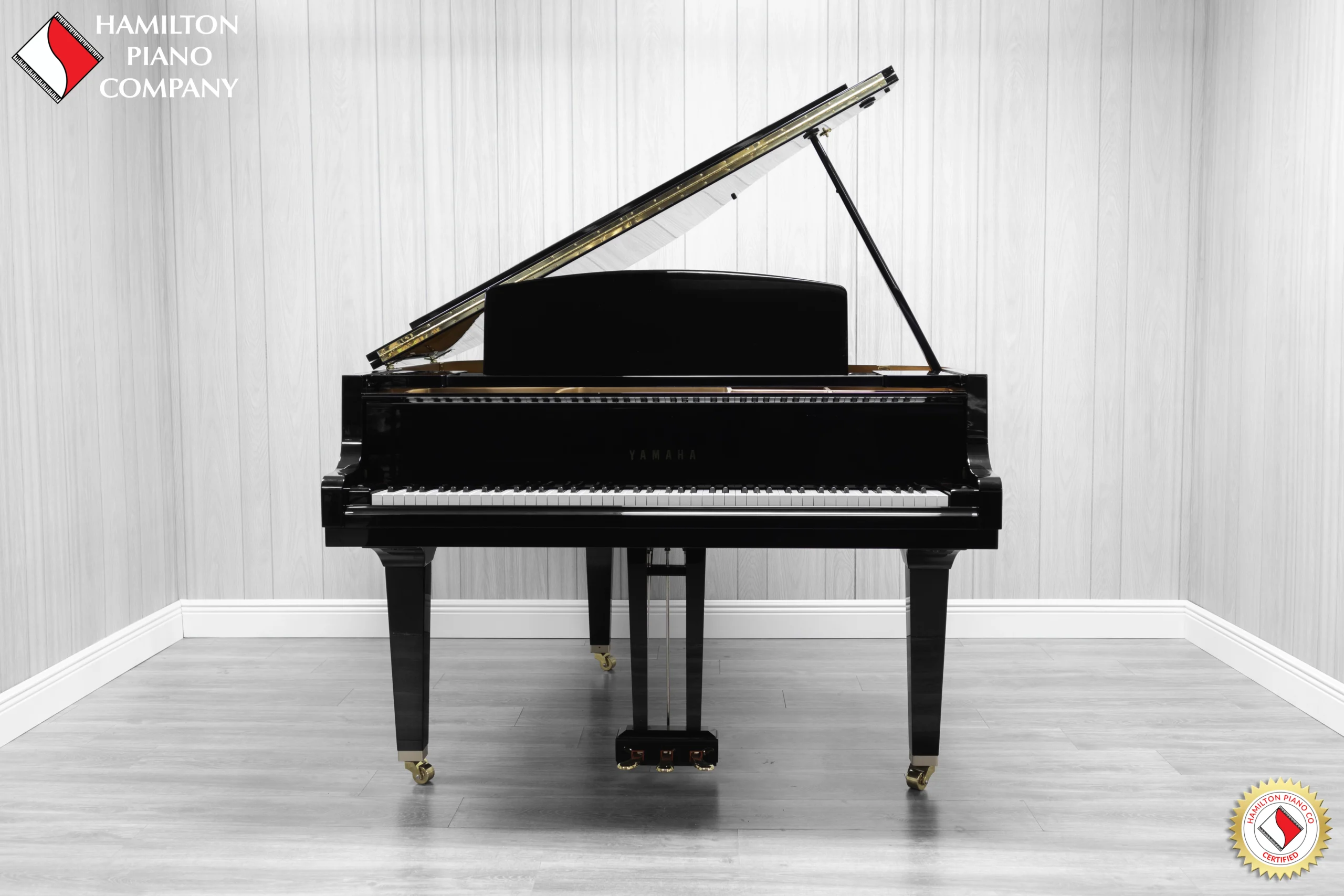 A Yamaha GH1 Baby Grand Piano in a high polish ebony finish.