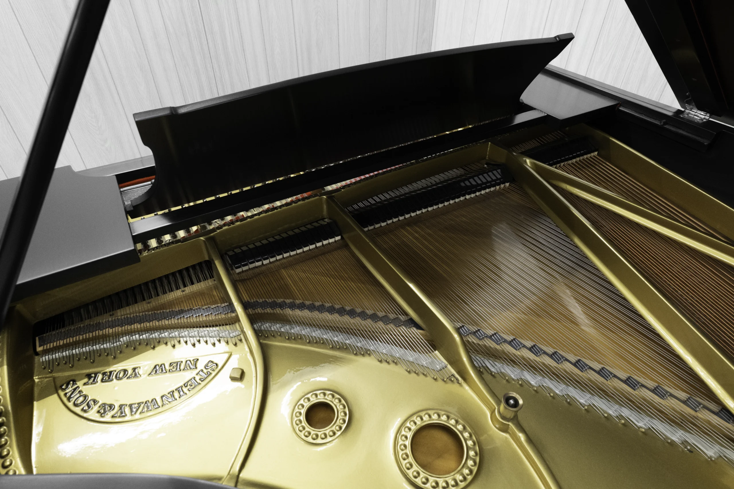 A 1911 Steinway A piano in a beautiful hand-rubbed satin ebony finish with nickel hardware. This image shows off the interior of the piano, including the harp and strings.
