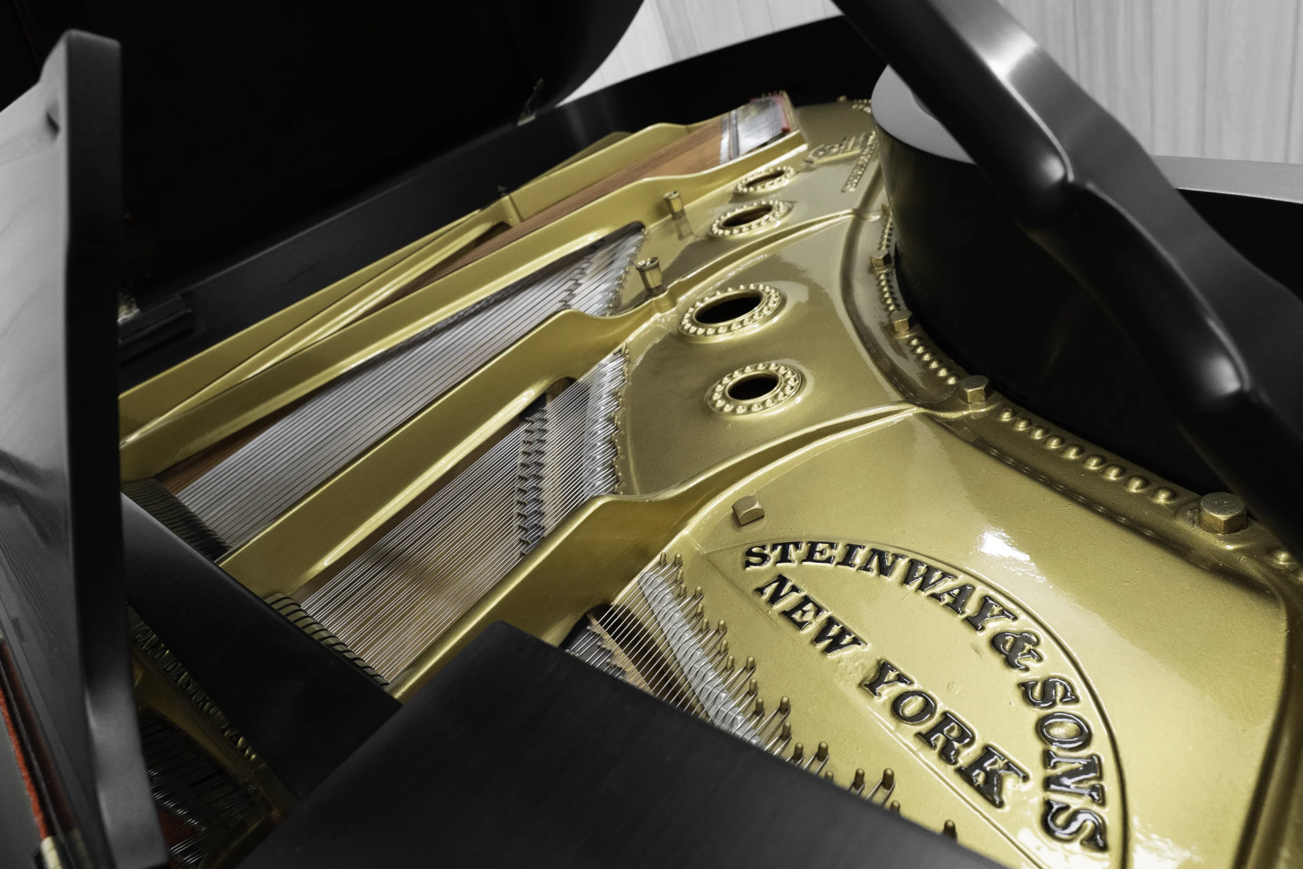 A 1911 Steinway A piano in a beautiful hand-rubbed satin ebony finish with nickel hardware. This image shows off the interior of the piano, including the harp and strings.