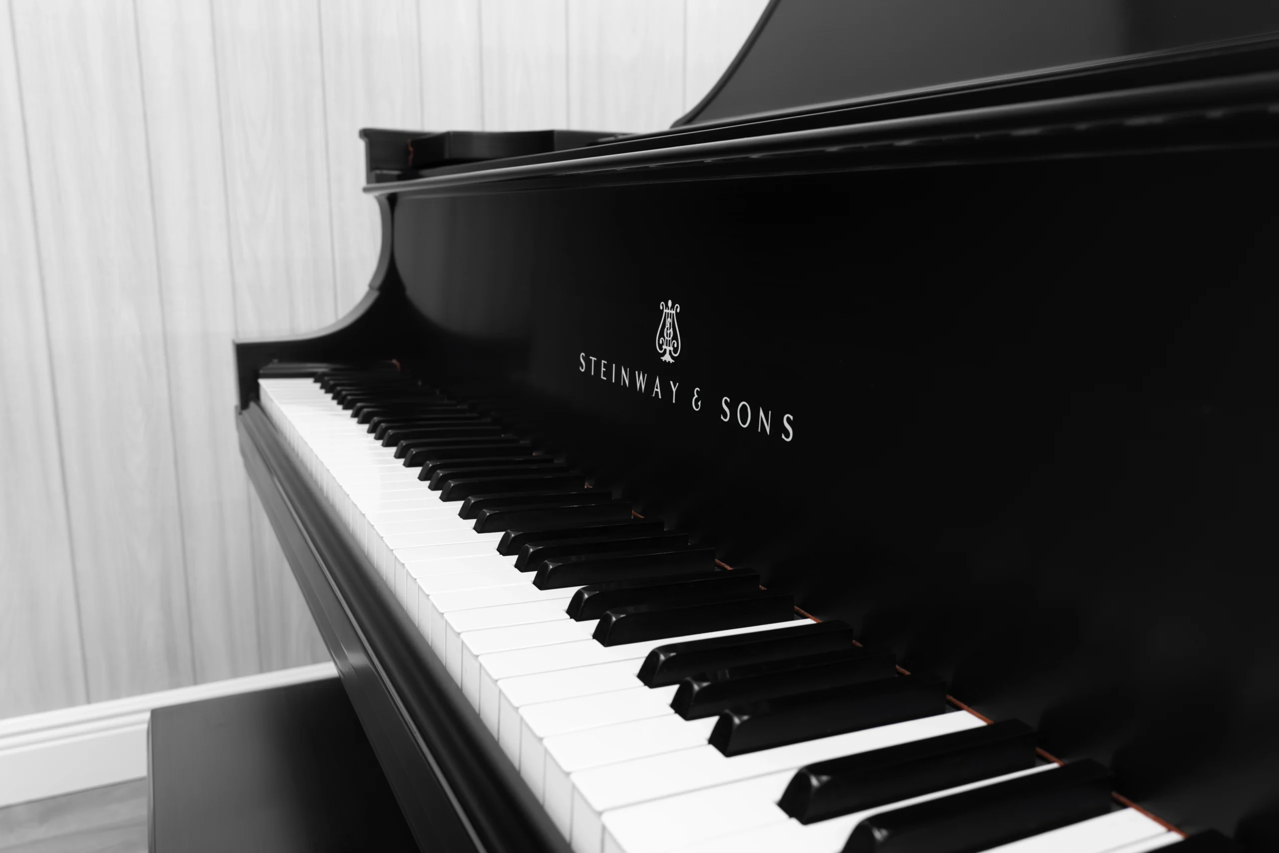 A 1911 Steinway A piano in a beautiful hand-rubbed satin ebony finish with nickel hardware. This image shows off the interior of the piano, including the harp and strings. This image shows off the keys and Steinway Logo on the fallboard.