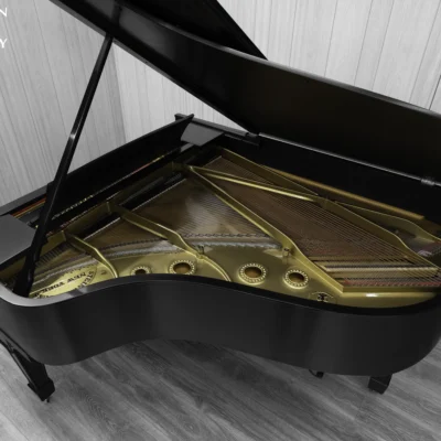 A 1911 Steinway A piano in a beautiful hand-rubbed satin ebony finish with nickel hardware. This image shows off the interior of the piano, including the harp and strings.