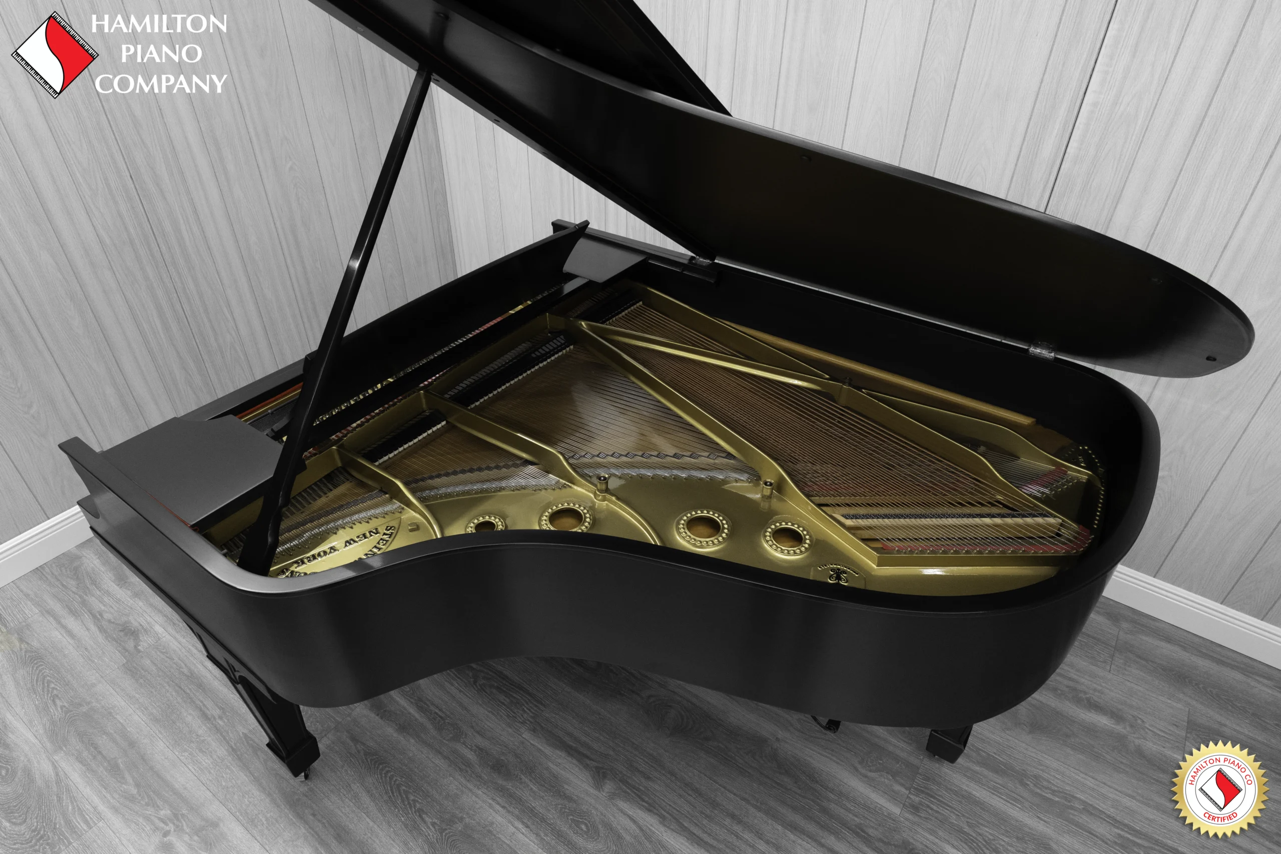 A 1911 Steinway A piano in a beautiful hand-rubbed satin ebony finish with nickel hardware. This image shows off the interior of the piano, including the harp and strings.