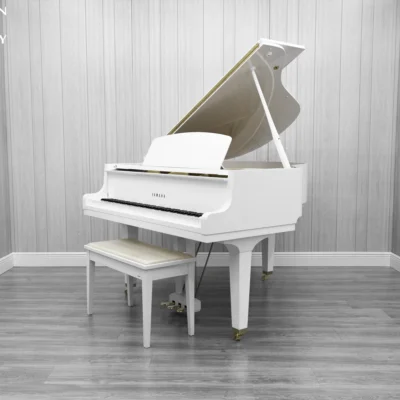 A Yamaha GH1 baby grand piano in a high polish white finish