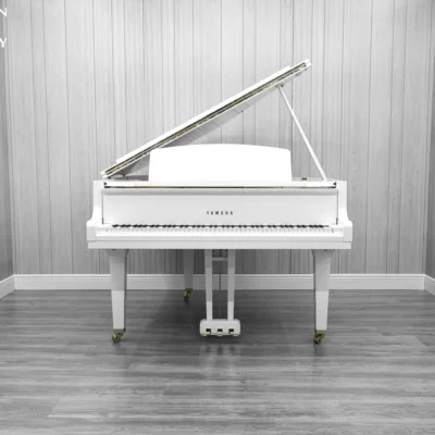 A Yamaha GH1 baby grand piano in a high polish white finish