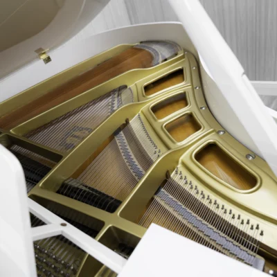 A Yamaha GH1 baby grand piano in a high polish white finish