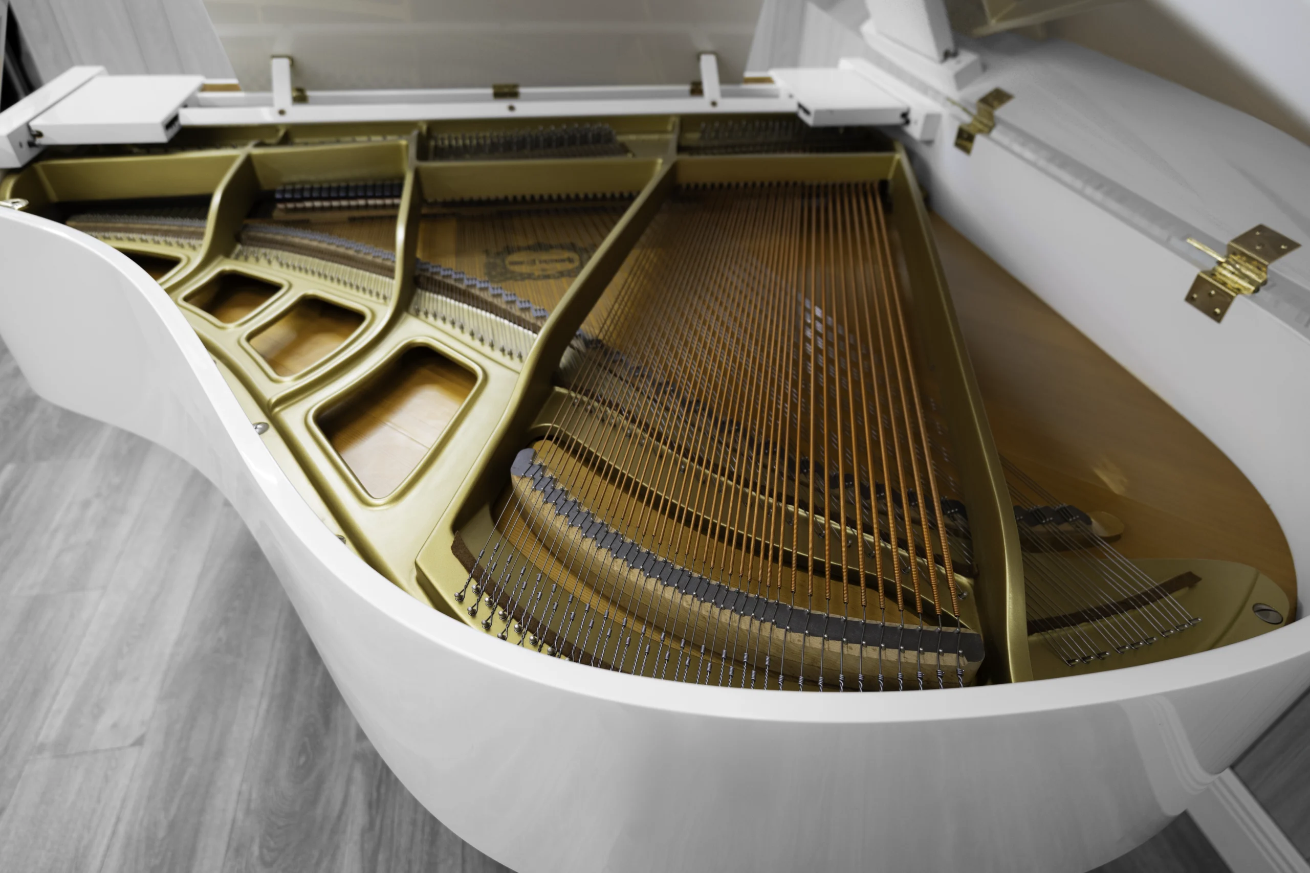 A Yamaha GH1 baby grand piano in a high polish white finish