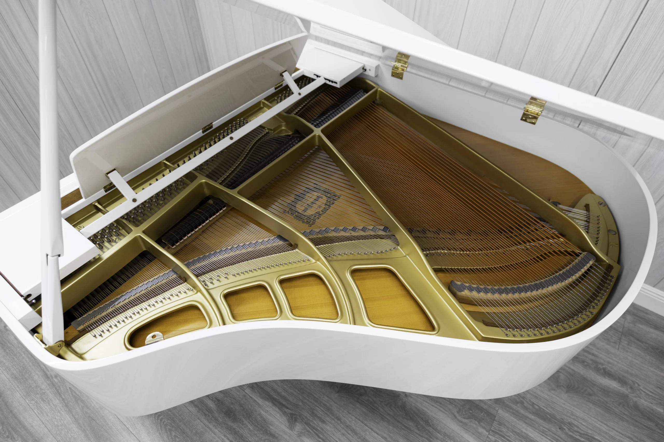 A Yamaha GH1 baby grand piano in a high polish white finish