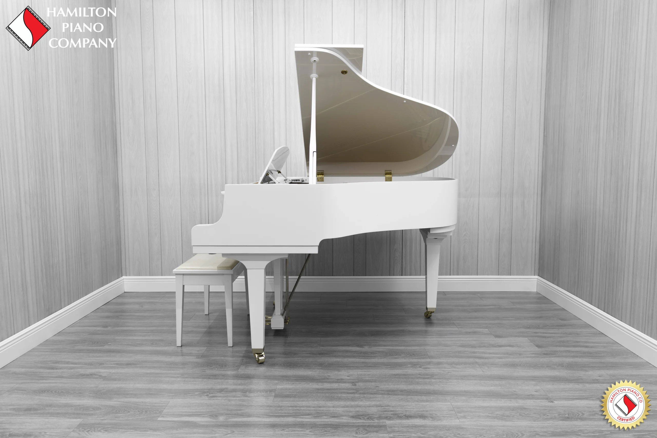 A Yamaha GH1 baby grand piano in a high polish white finish