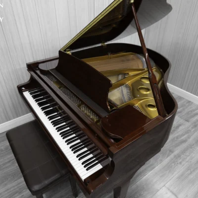 Haileer baby grand piano in high polish mahogany.