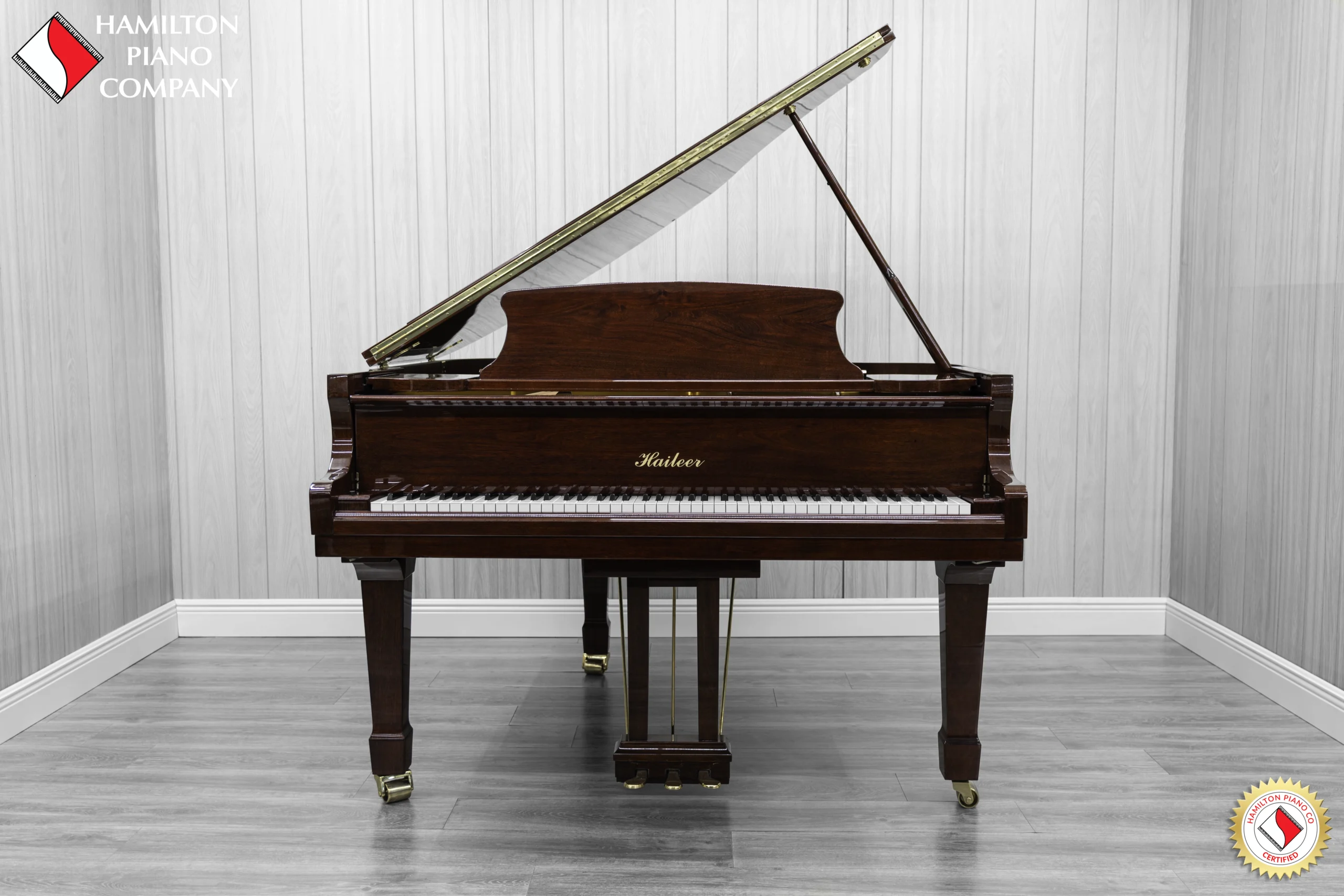 Haileer baby grand piano in high polish mahogany.