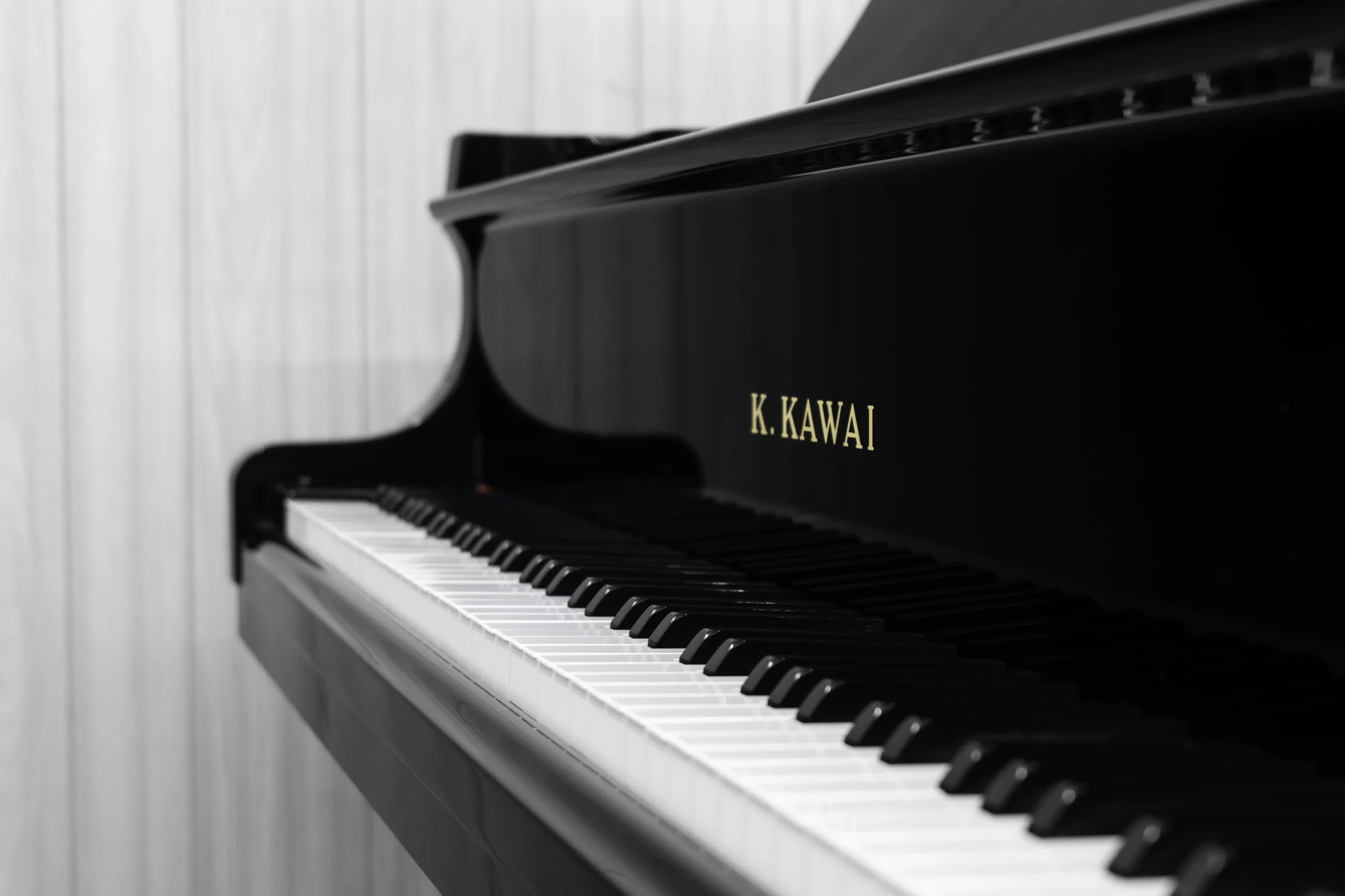 A Kawai RX-3 grand piano in a high-polish ebony finish.