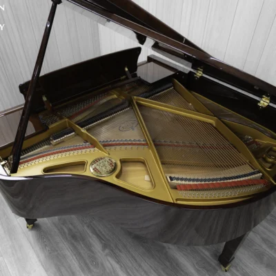 Petrof baby grand piano in high polish mahogany finish with a good view of the interior including the harp and strings