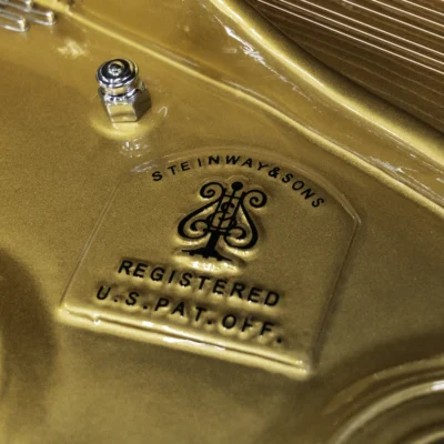 a close up on the Steinway logo on the harp of a Steinway D concert grand piano
