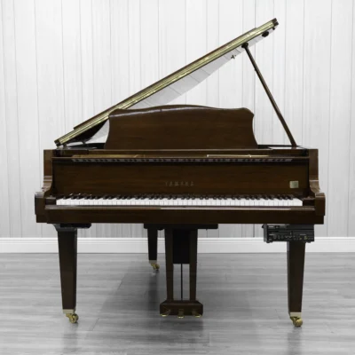 A pre-owned Yamaha GH1 baby grand piano in a beautiful mahogany finish with brass hardware.
