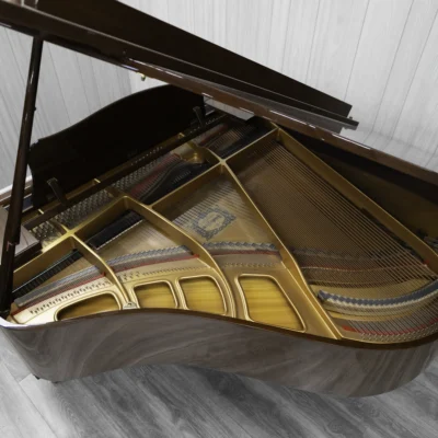 A pre-owned Yamaha GH1 baby grand piano in a beautiful mahogany finish with brass hardware.